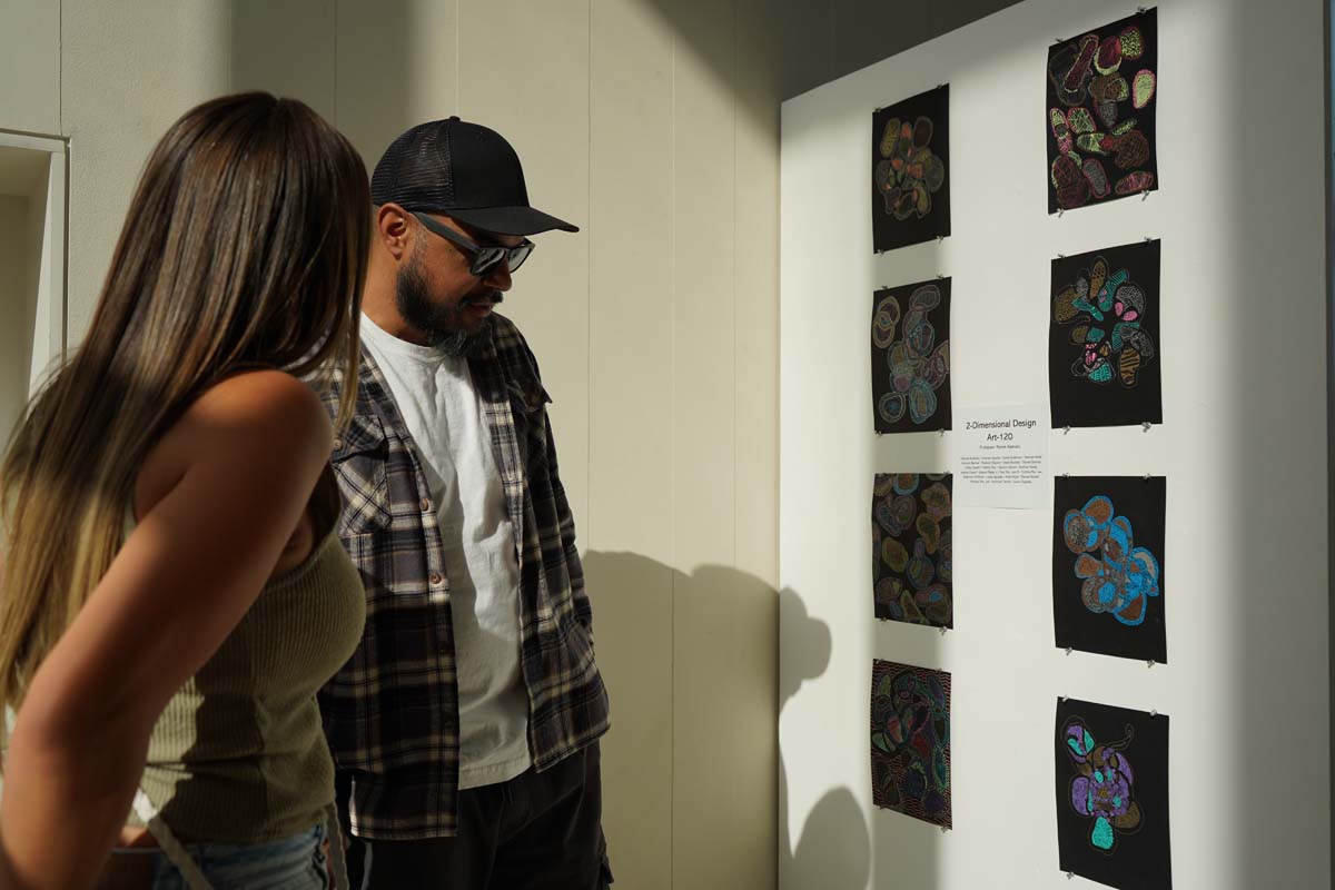 Students attend CHC Fall student art exhibit.