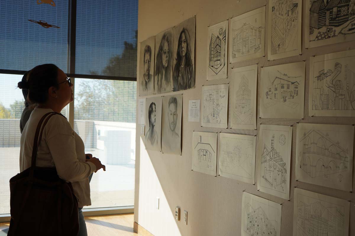 Students attend CHC Fall student art exhibit.