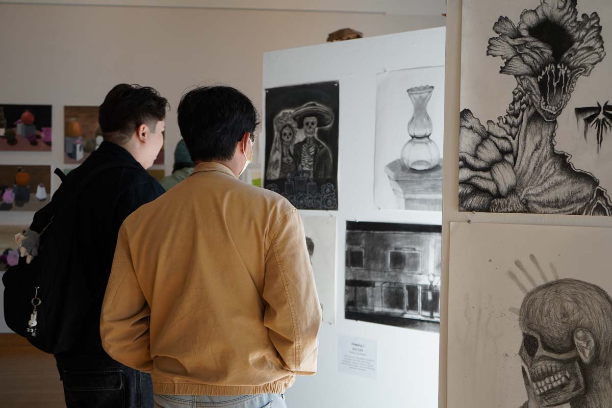 Students attend CHC Fall student art exhibit.