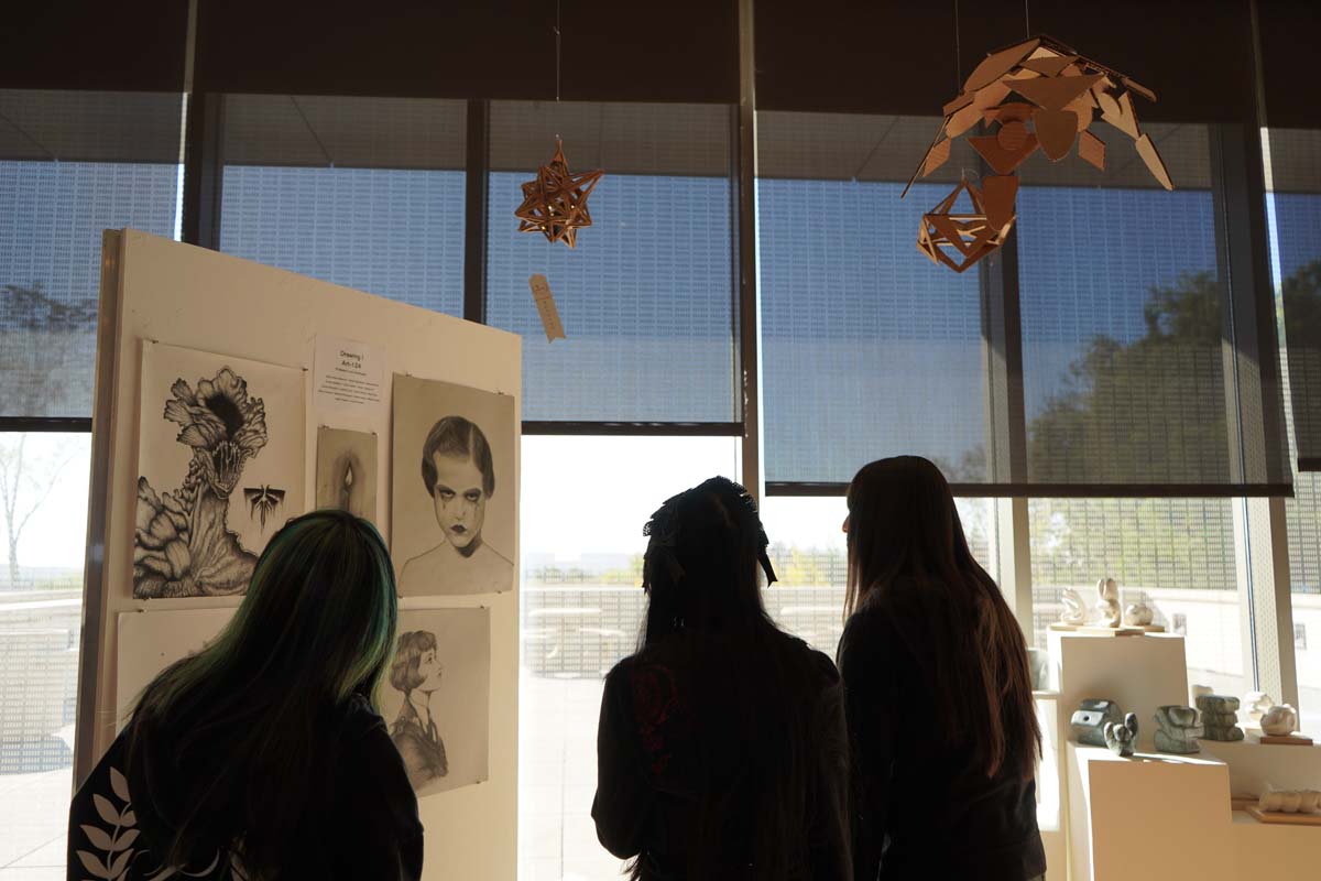 Students attend CHC Fall student art exhibit.