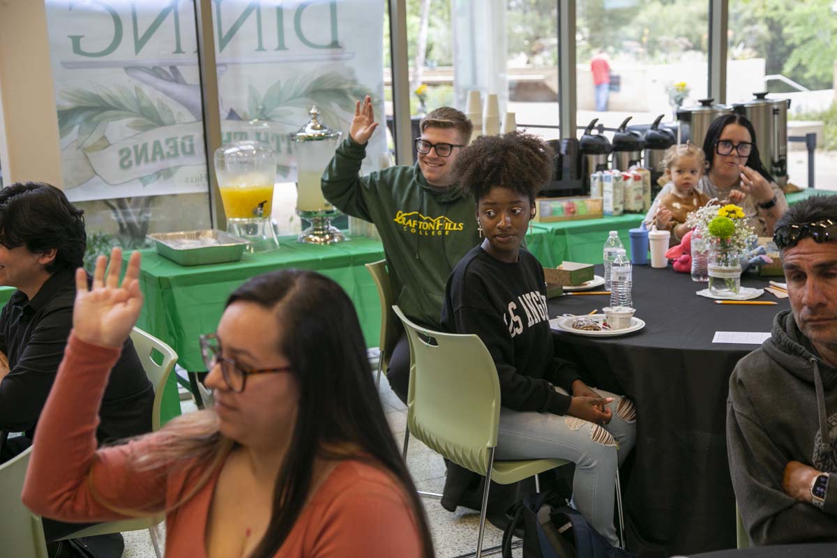 Students celebrate making deans list at event.