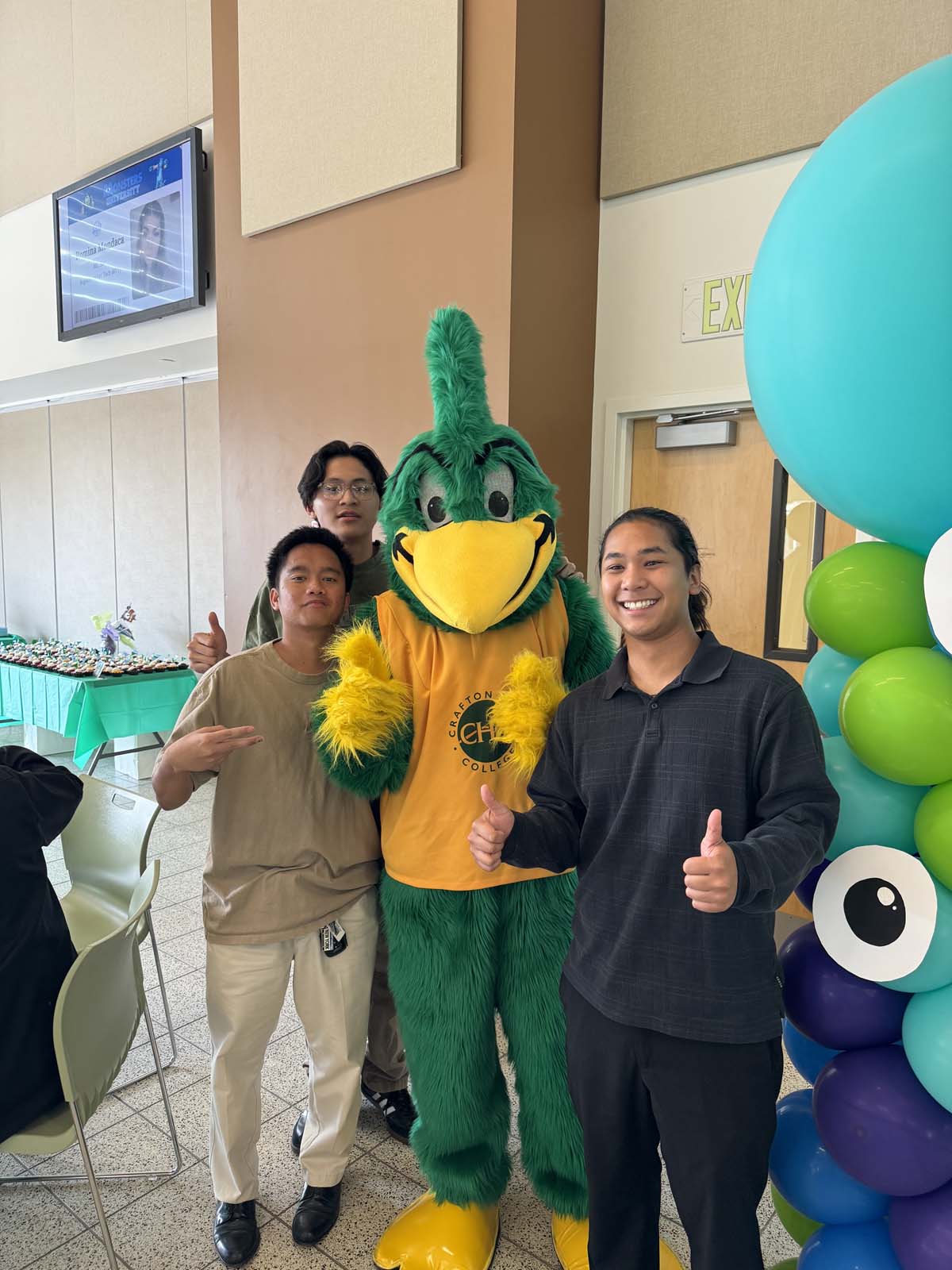 Students attend Transfer Dinner celebration with mascot Ryker.