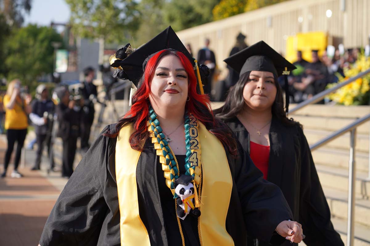 Graduates walk to stage at CHC's Commencement 2024.