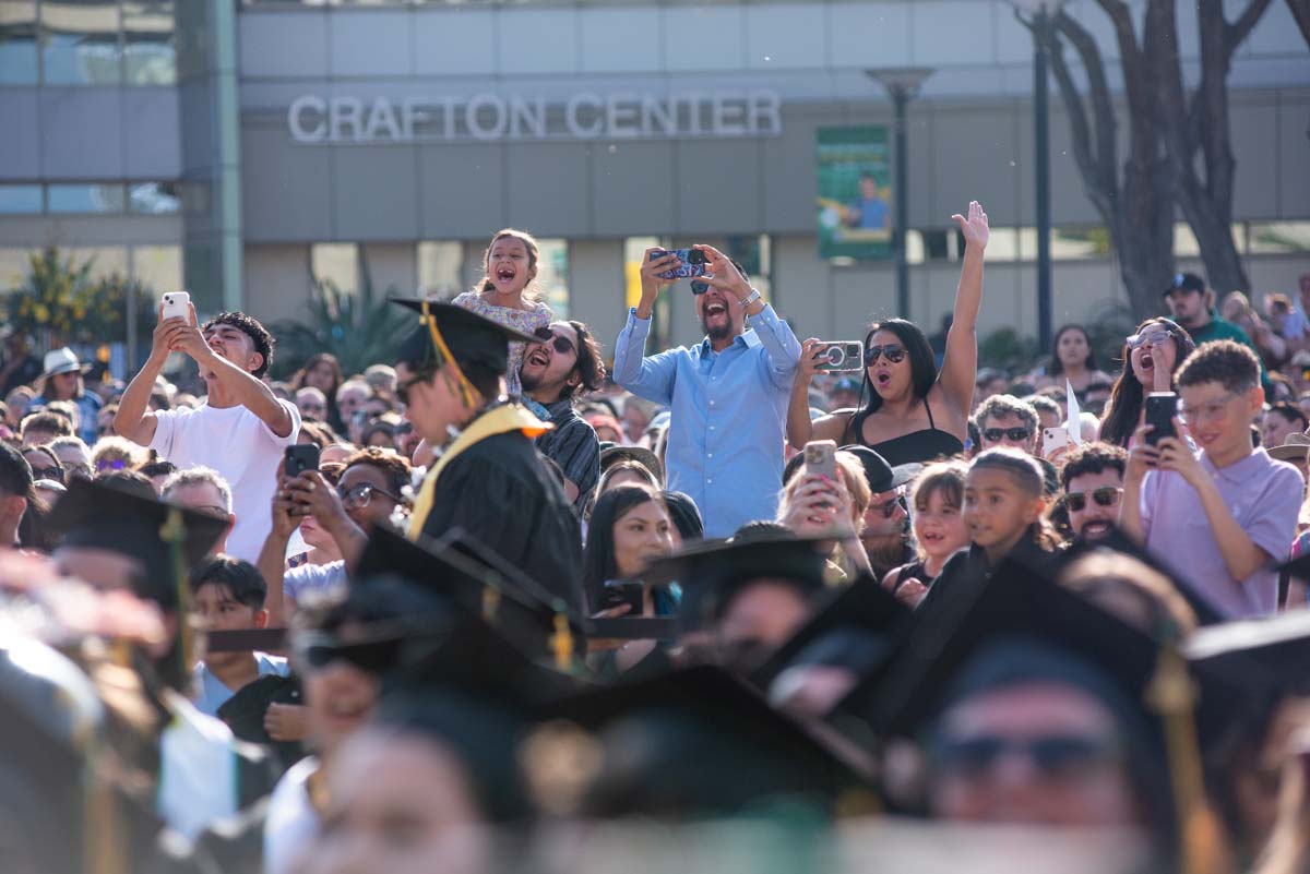 Graduates walk across stage at CHC Commencement 2024.